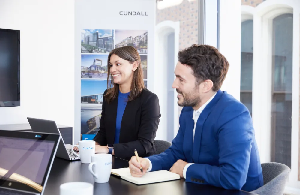 Cundall Perth meeting room with staff sitting with laptop and pads