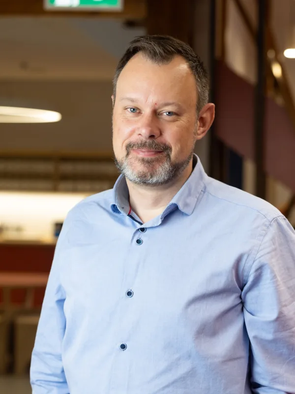 Cormac Farrell in a blue shirt with a blurred office background