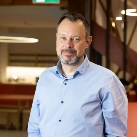 Cormac Farrell in a blue shirt with a blurred office background