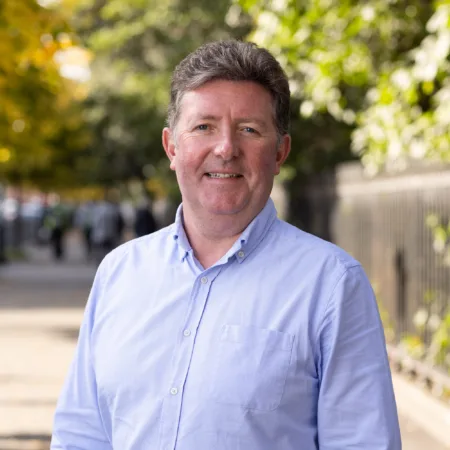 William Dolan standing outside wearing a blue shirt