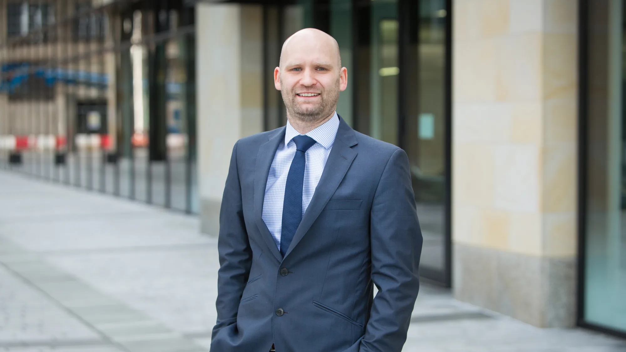 Robert in a suit, stood outside of the Edinburgh office