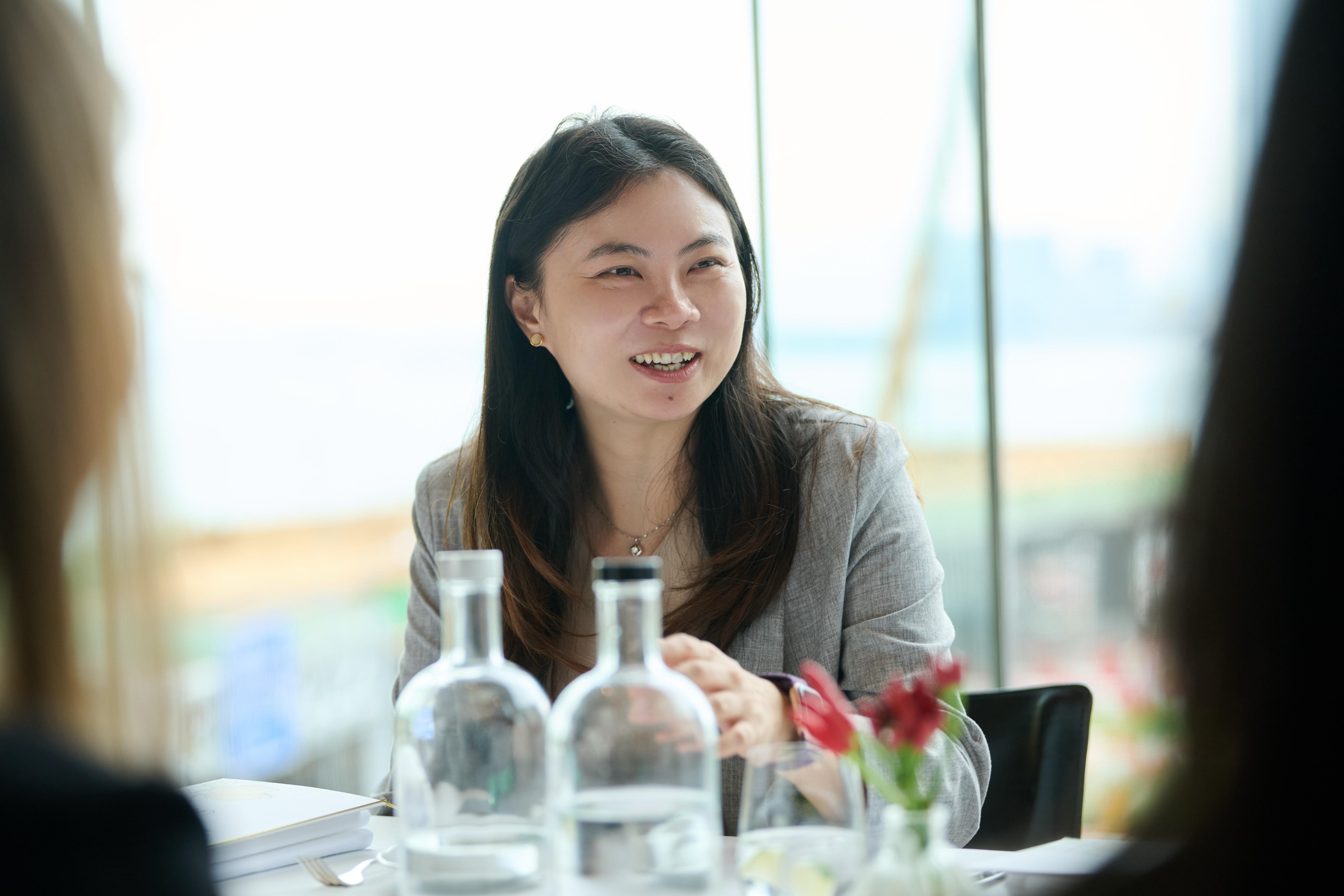 Ida Huang in grey jacket