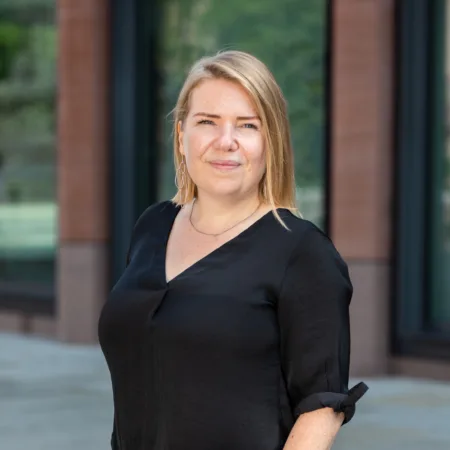 Barbara Sacha in front office class and cladded building