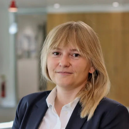 Gosia in a white open collar shirt and dark blue suit jacket
