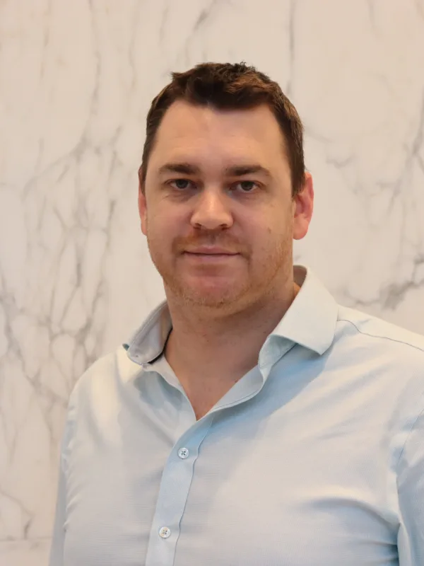 Jamie Cameron looking towards the camera in a light blue shirt