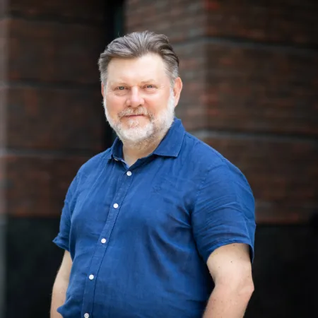 Malcolm Howe in front of office building