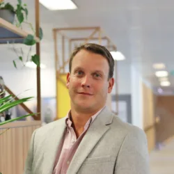 Head and sholders in Robin standing in the London office