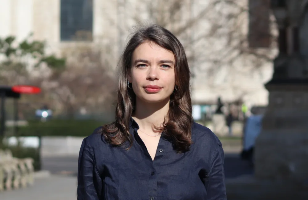 Head and sholders shot of Vera wearing a dark blue top with St Pauls cathedral in background