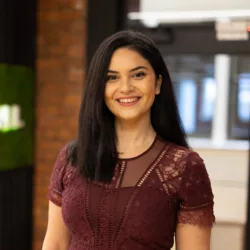 Bianca Spoeala in red dress with office background