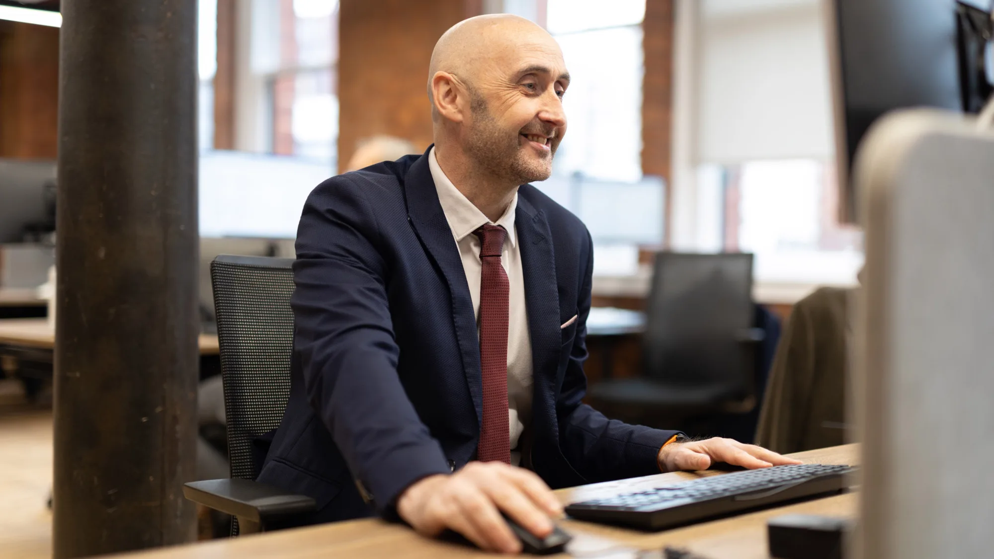 Gavin Bonner at a desk looking at the computer screen