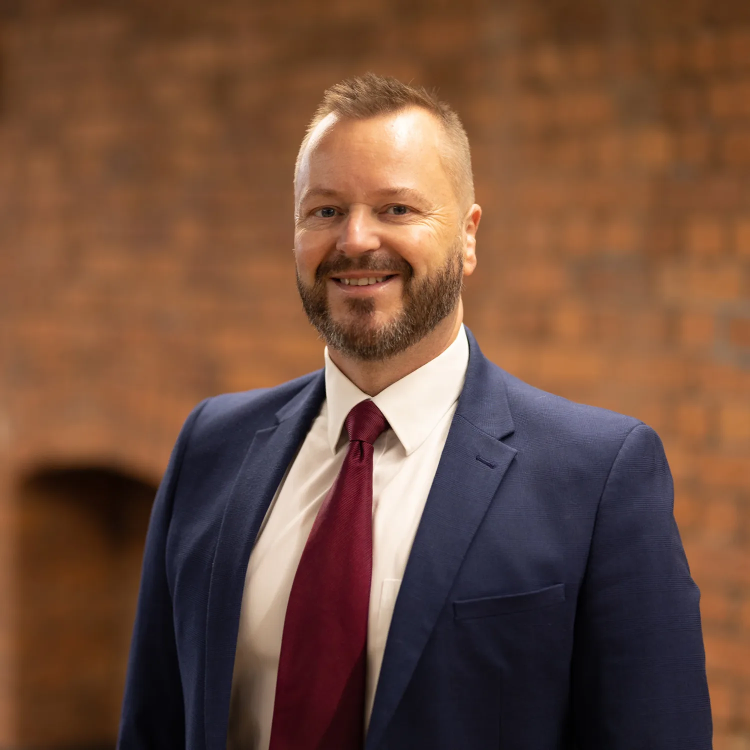 Mark Moore in office with a brick background