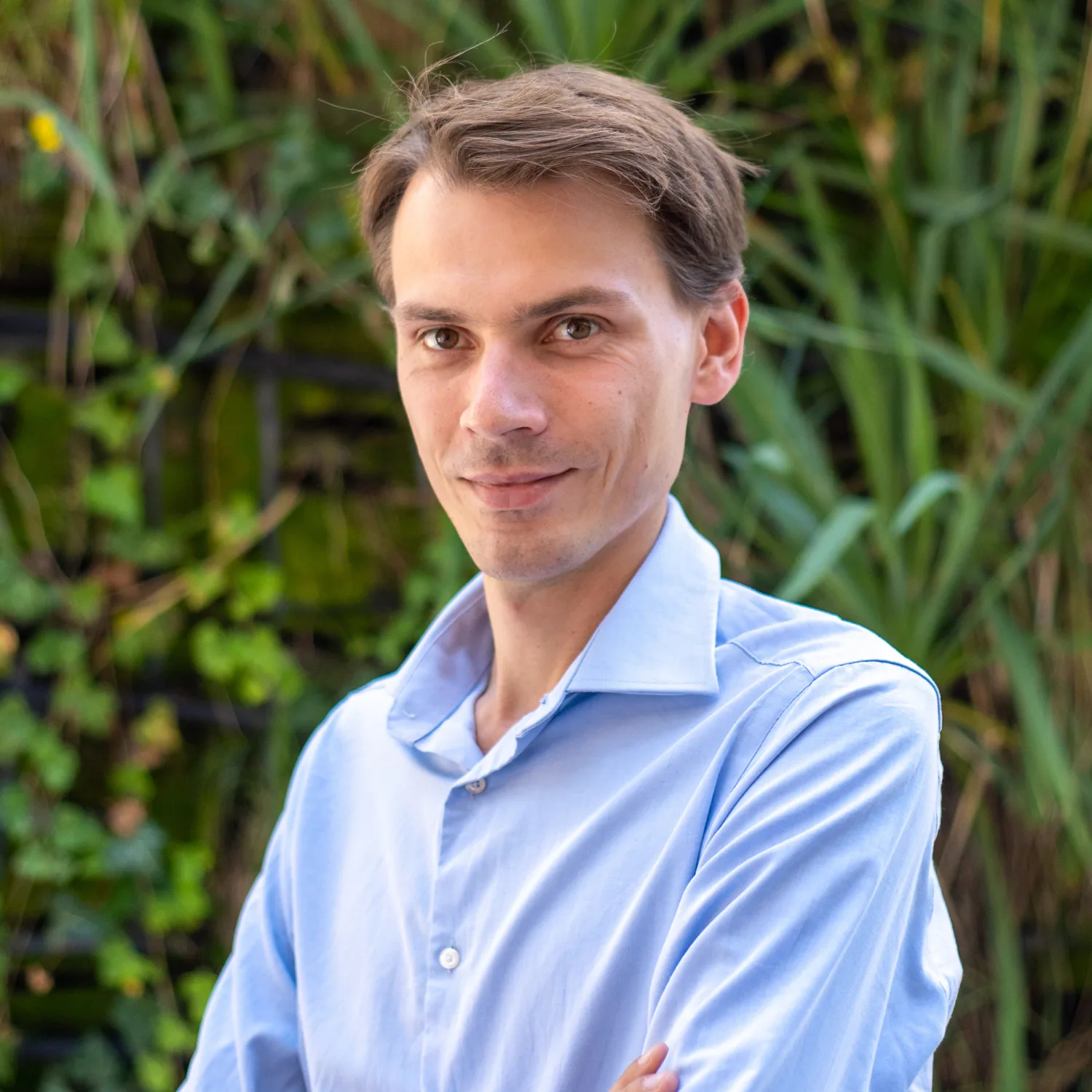 Michal Wojcik smiling for a photo in-front of some Fiona