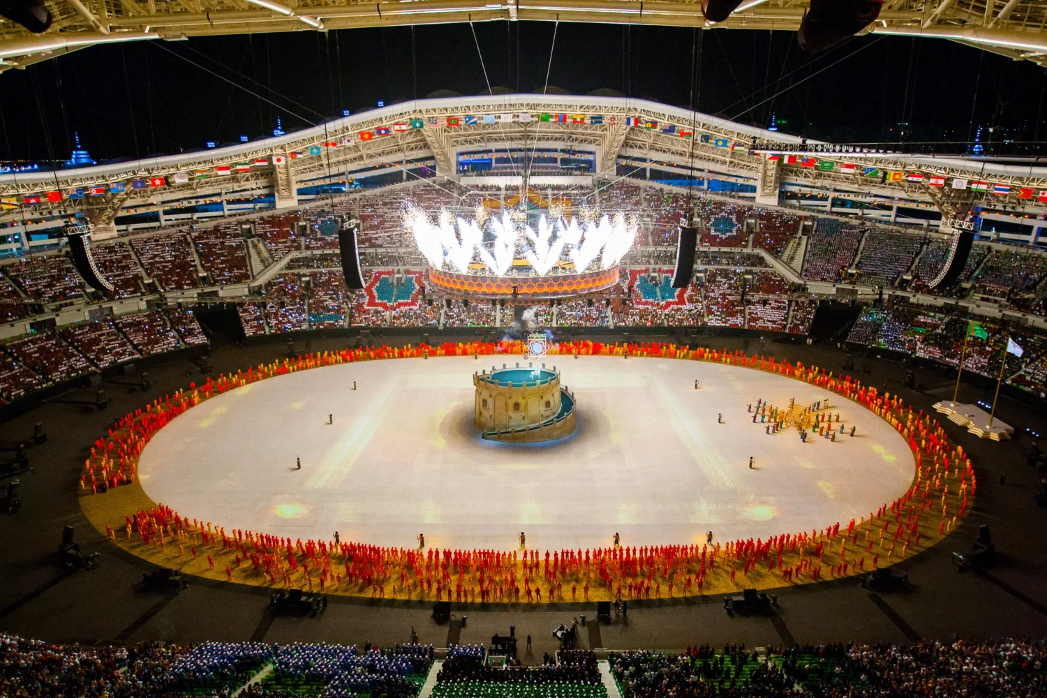 Opening ceremony with pyrotechnics lighting up from the central suspended ring