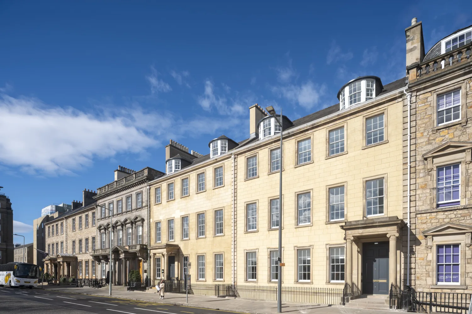 Exterior view of Andrews Square building with adjacent street and open sky in the background.
