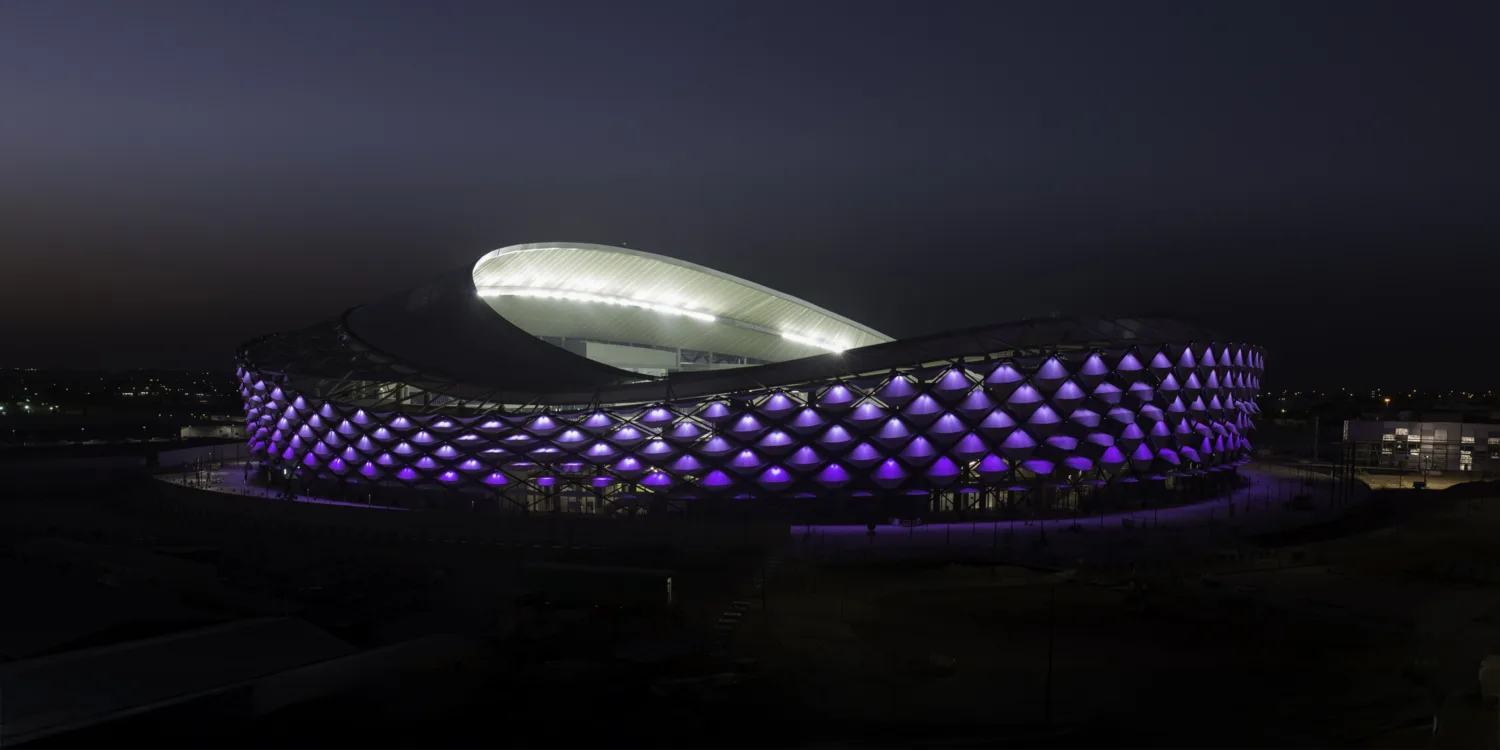 Illuminated night time external view of stadium