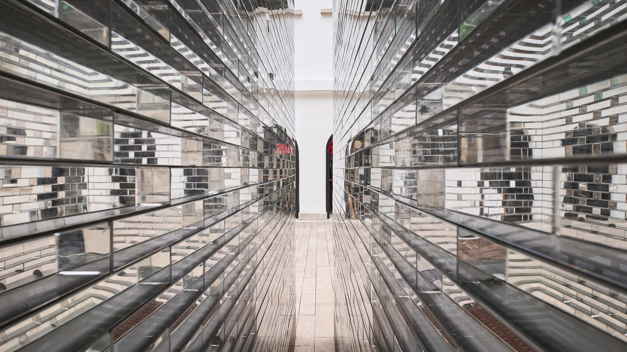 Perspective close up angle of glass sculpture installation by artist Alicja Kwade