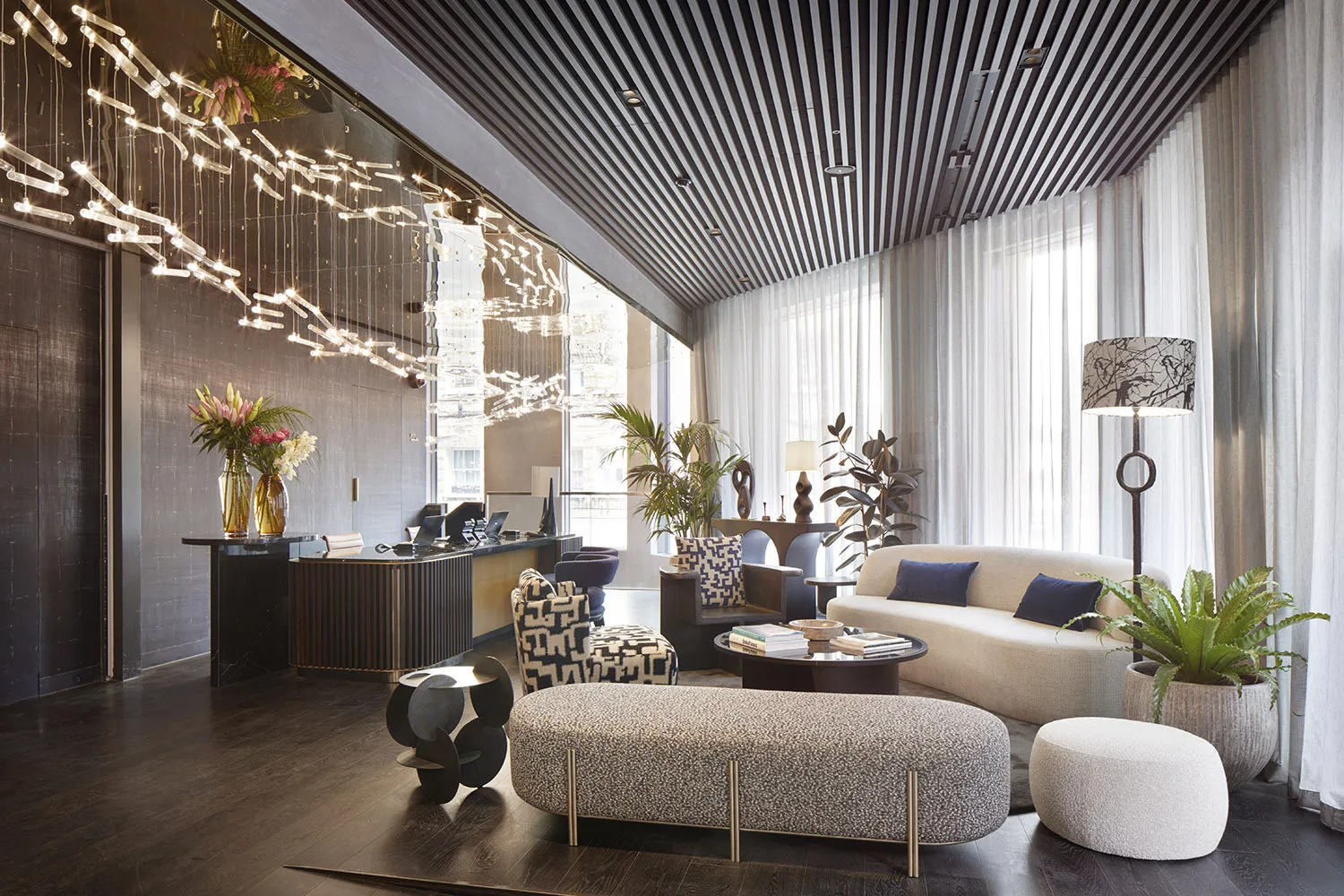 Hotel reception area with wooden floor and light coloured furnishings