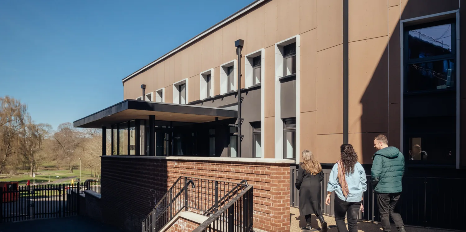 People walking into entrance of Animal Studies Centre on a clear sunny day.