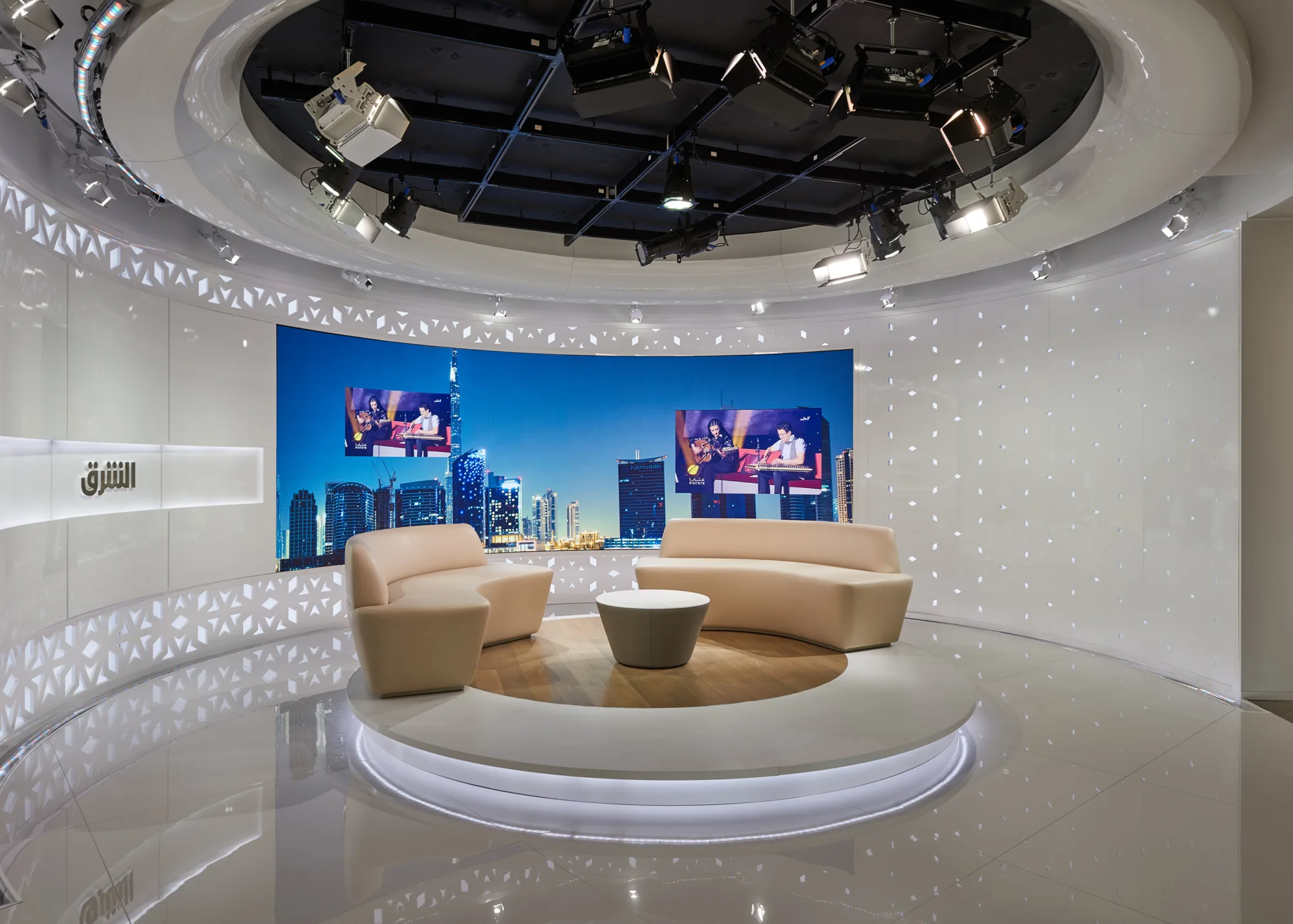 Illuminated Studio Set with two beige sofas at Ashraq News Services Dubai
