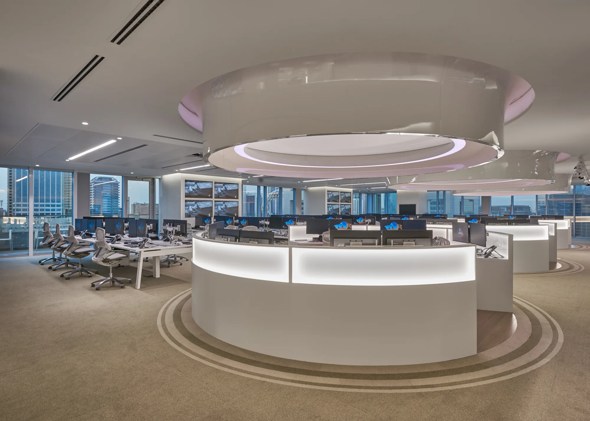 A room full of computer workstations at Ashraq News Services Dubai office with an amazing panoramic view of high-rise buildings