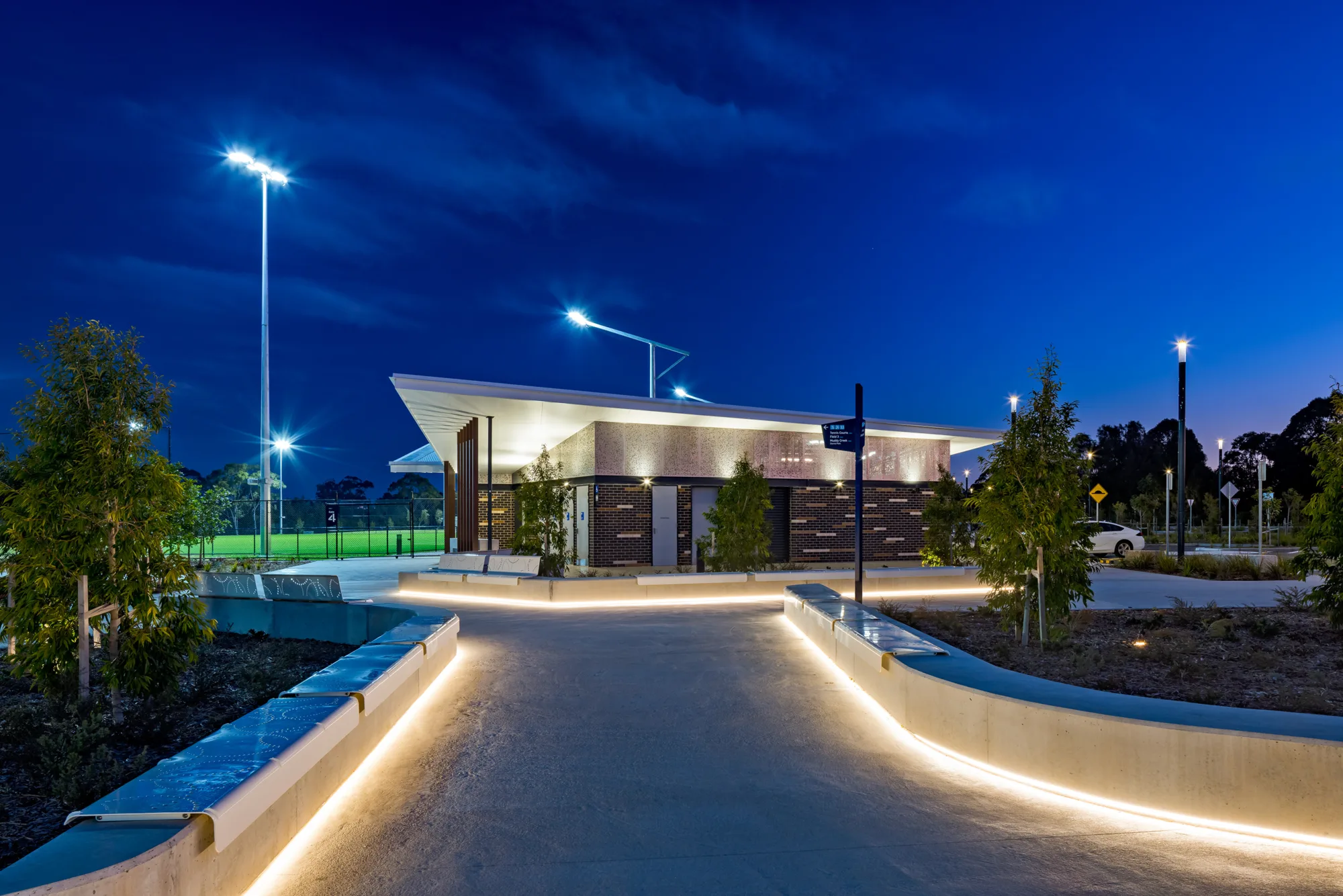 Lighting along pathways leading to amenities building.