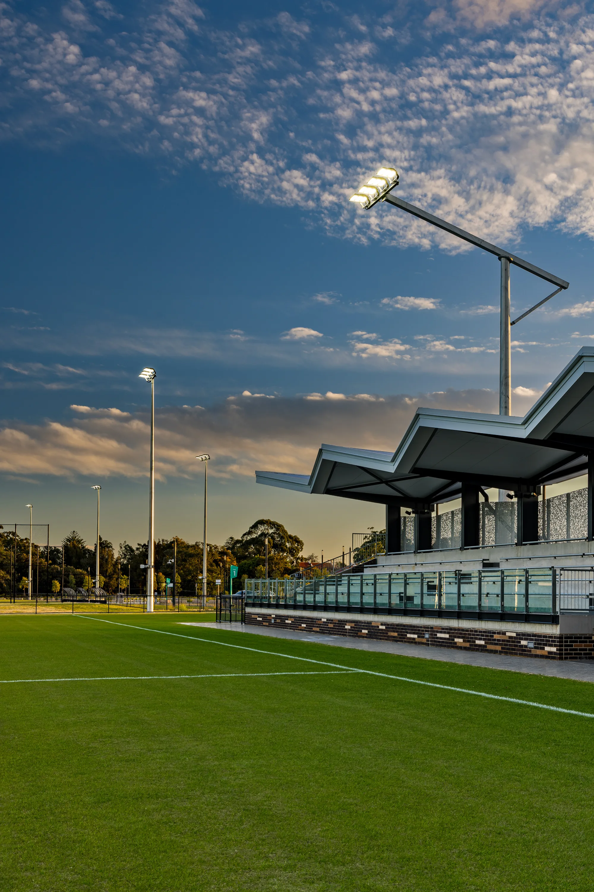 Stand at twilight with cantilevered floodlights.