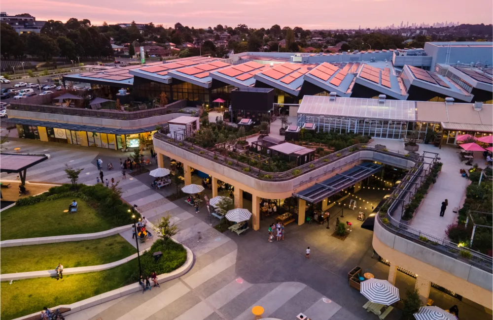 Aerial view of complex at dusk including solar panels and surrounds.