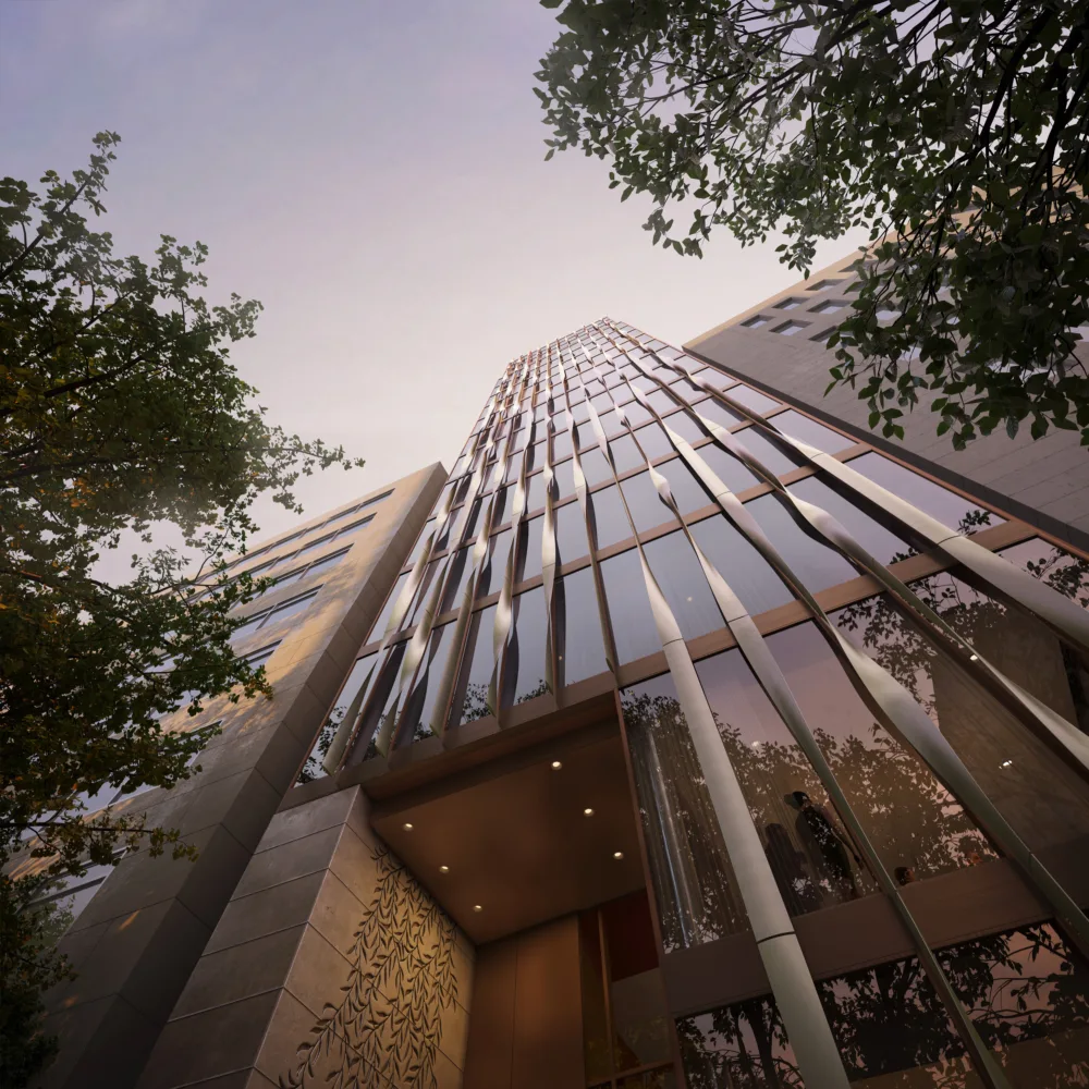 View from the ground of the front of the building showing a curved façade design and some internal features