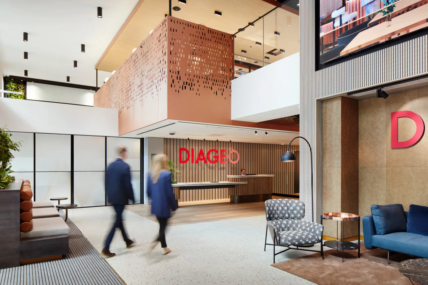 Two people walking through the branded Diageo reception