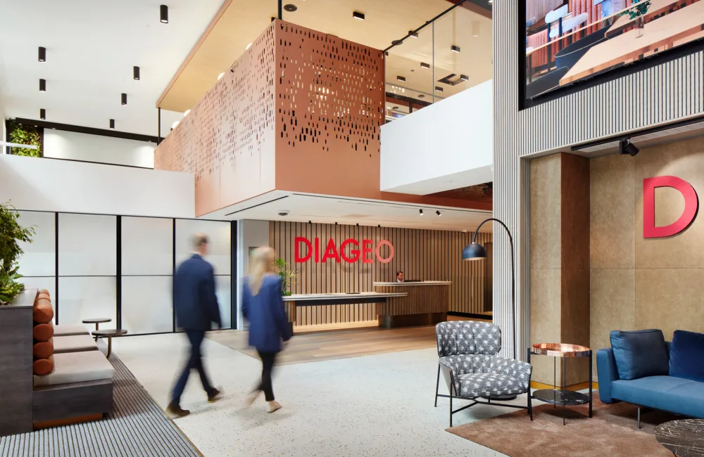 Two people walking through the branded Diageo reception