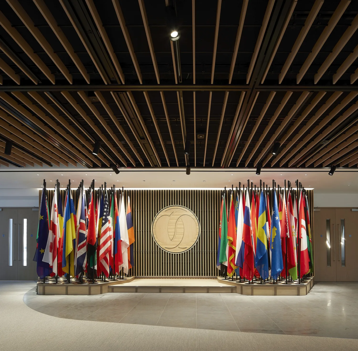 Reception shot with european flags on poles marble floors and pine ceiling