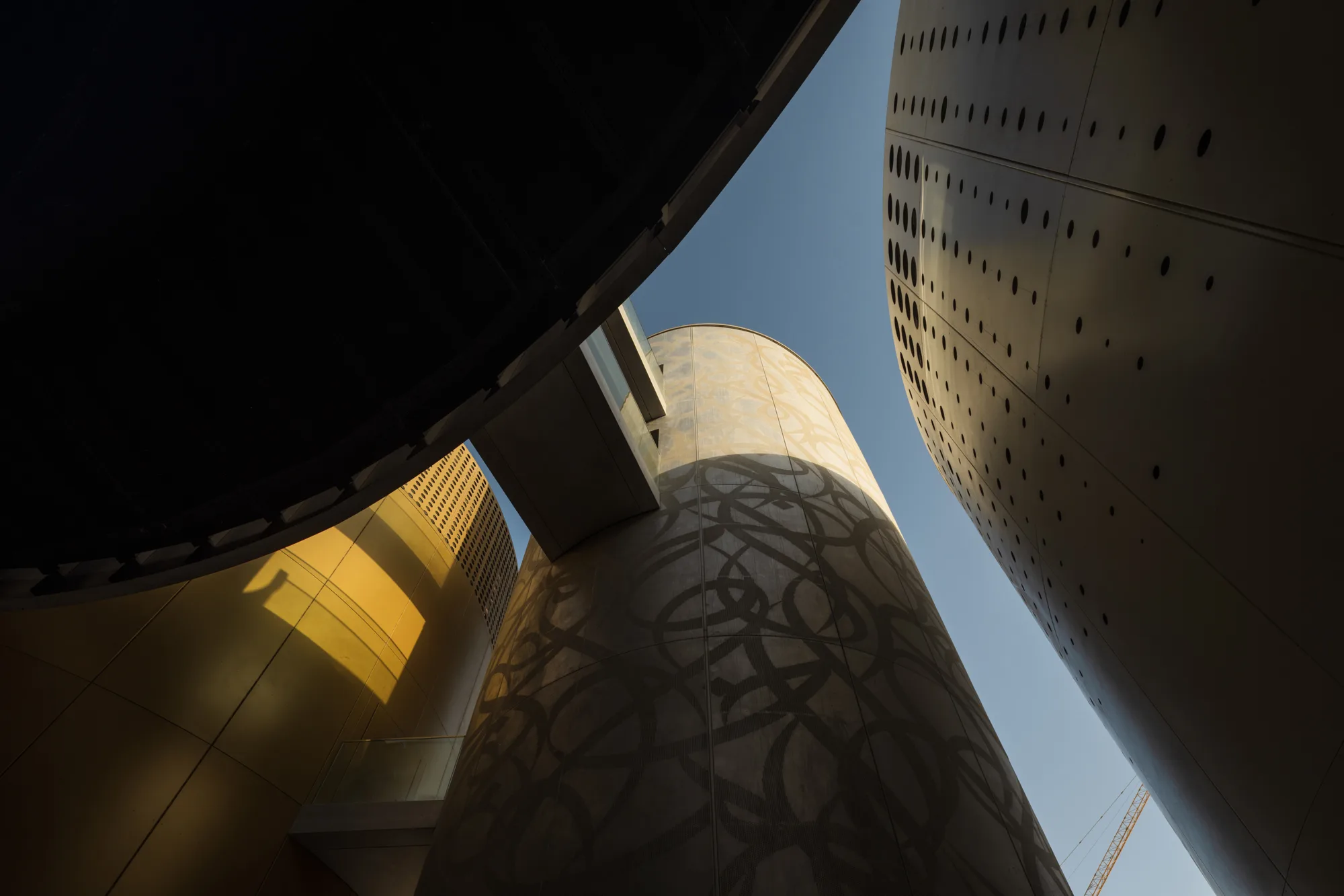 The ENOC Pavillion at the EXPO 2020 in Dubai with a closer view of the fuel storage like structures covered with arabic ornament design.