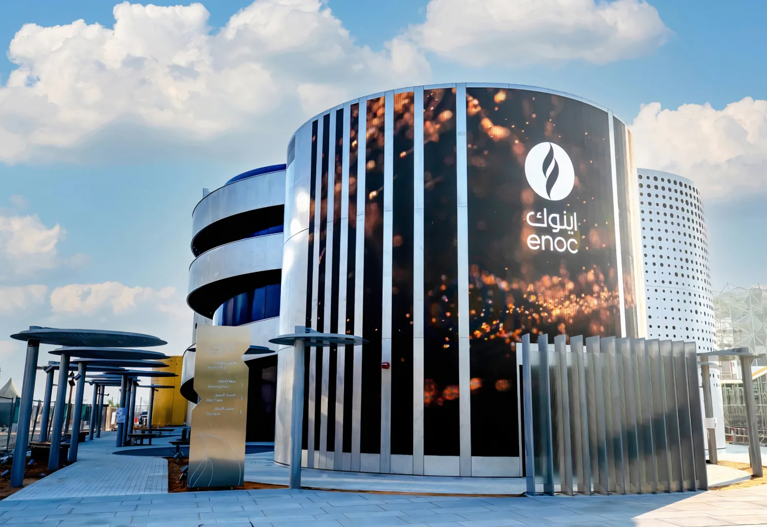 Front view of the ENOC Pavillion at the EXPO 2020 in Dubai with a clear blue sky.