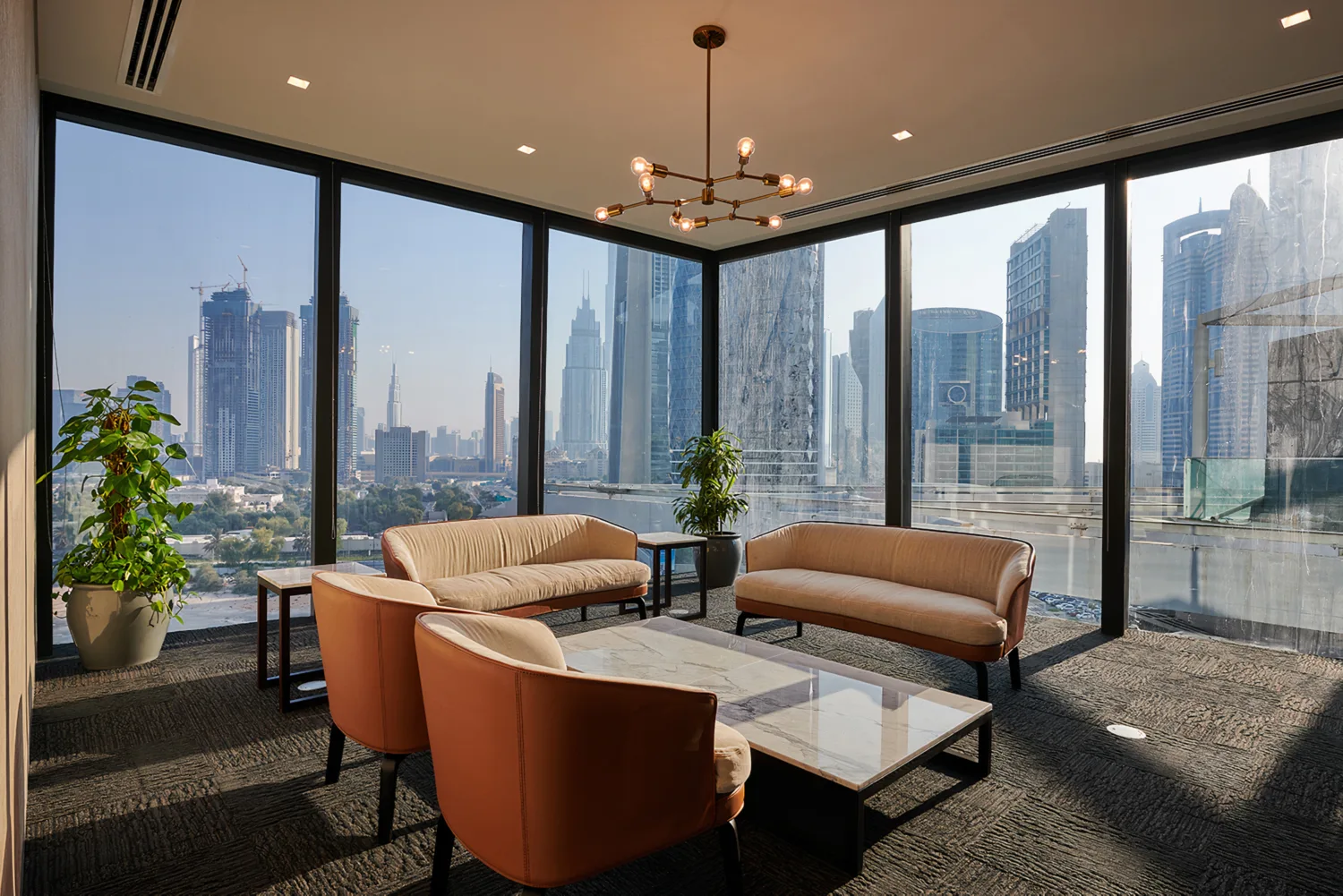 Ernst & Young Dubai office room with good natural light and a cosy sofa set and center table