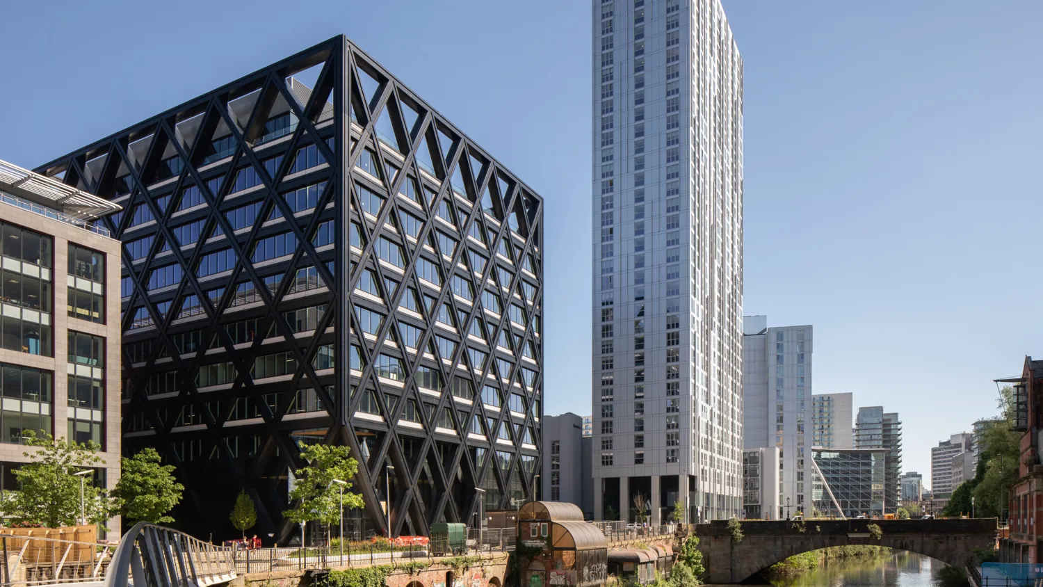 Office building render with bridge pathway leading to building with a dark grey cut out facade