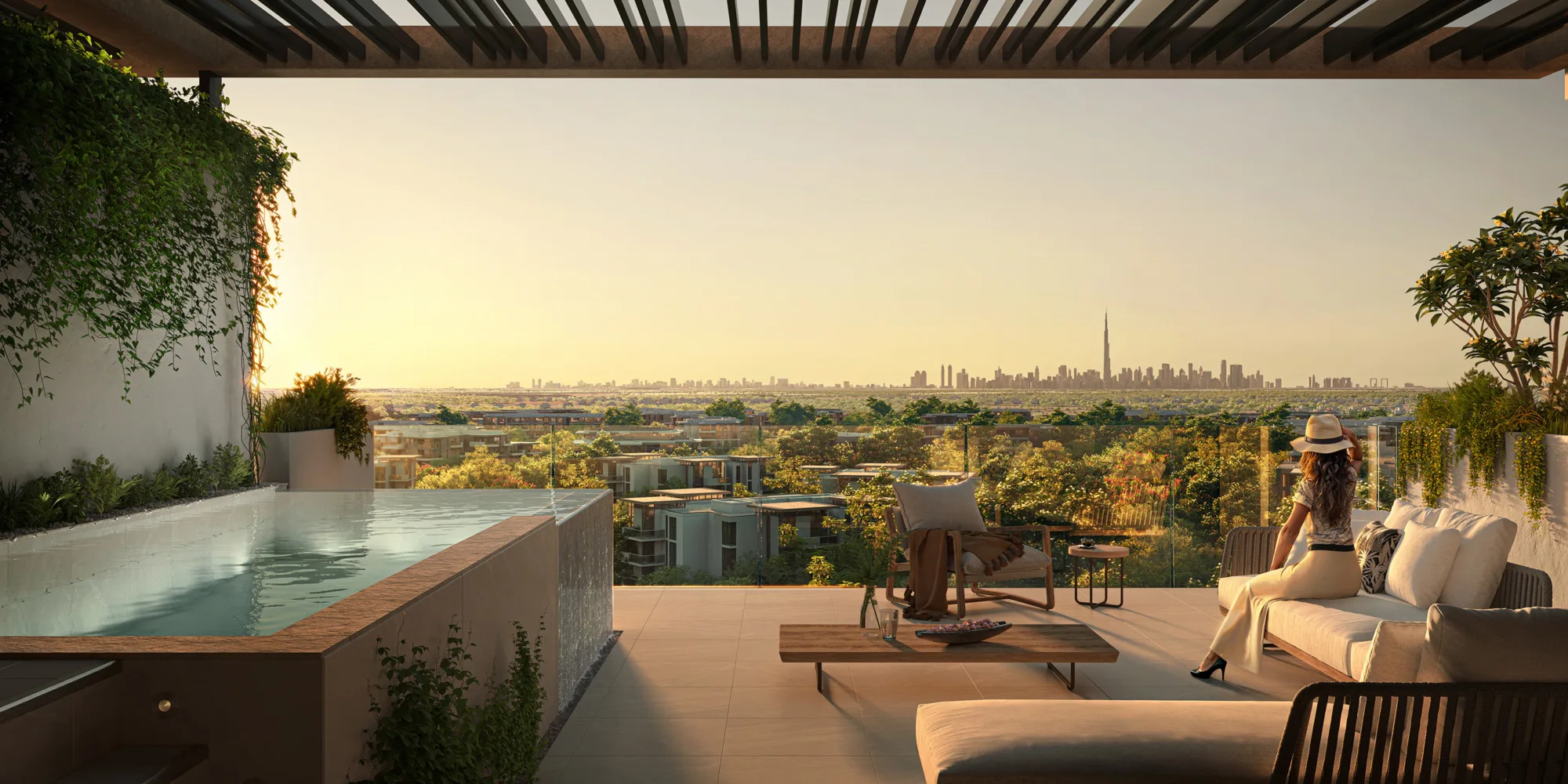 An outdoor terrace with a rectangular infinity pool, seating furniture, and potted plants, overlooking a wooded area and distant city skyline with tall towers, viewed under a slatted roof at sunset.