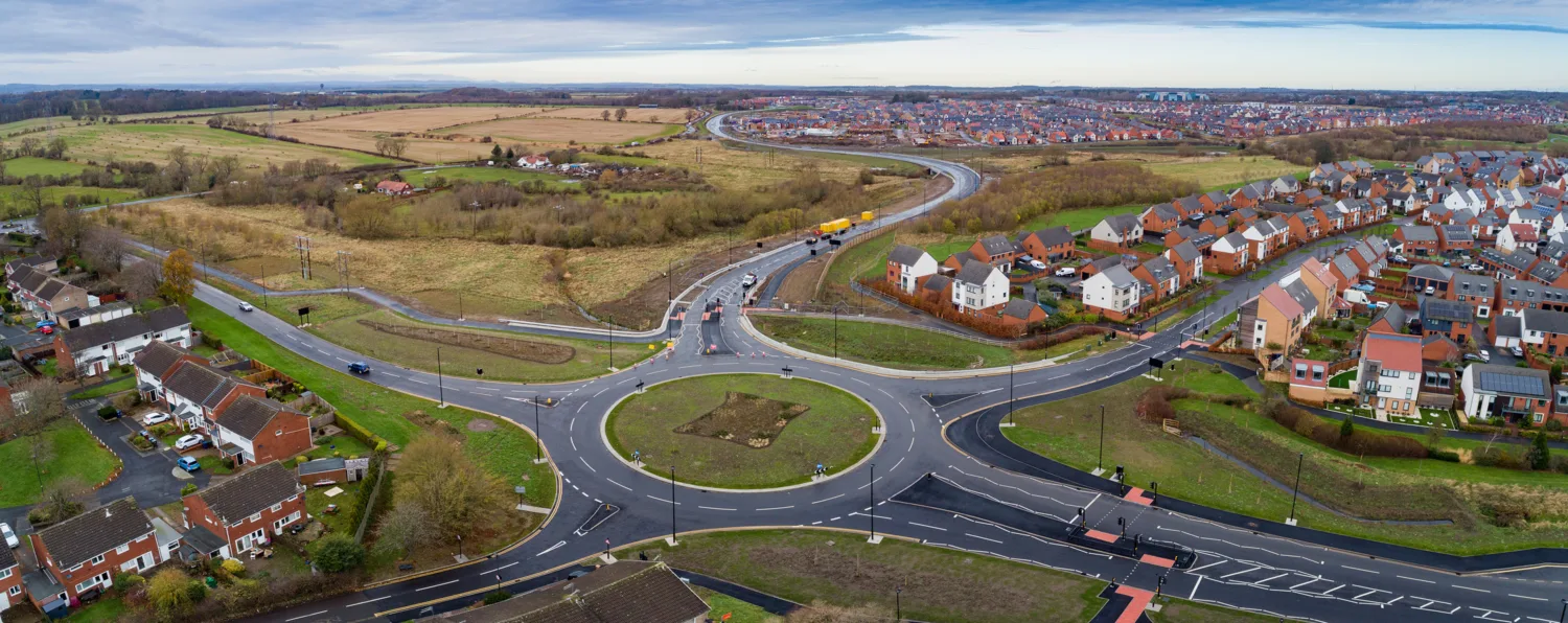 Areal view of a 5 exit roundabout in a green residential area