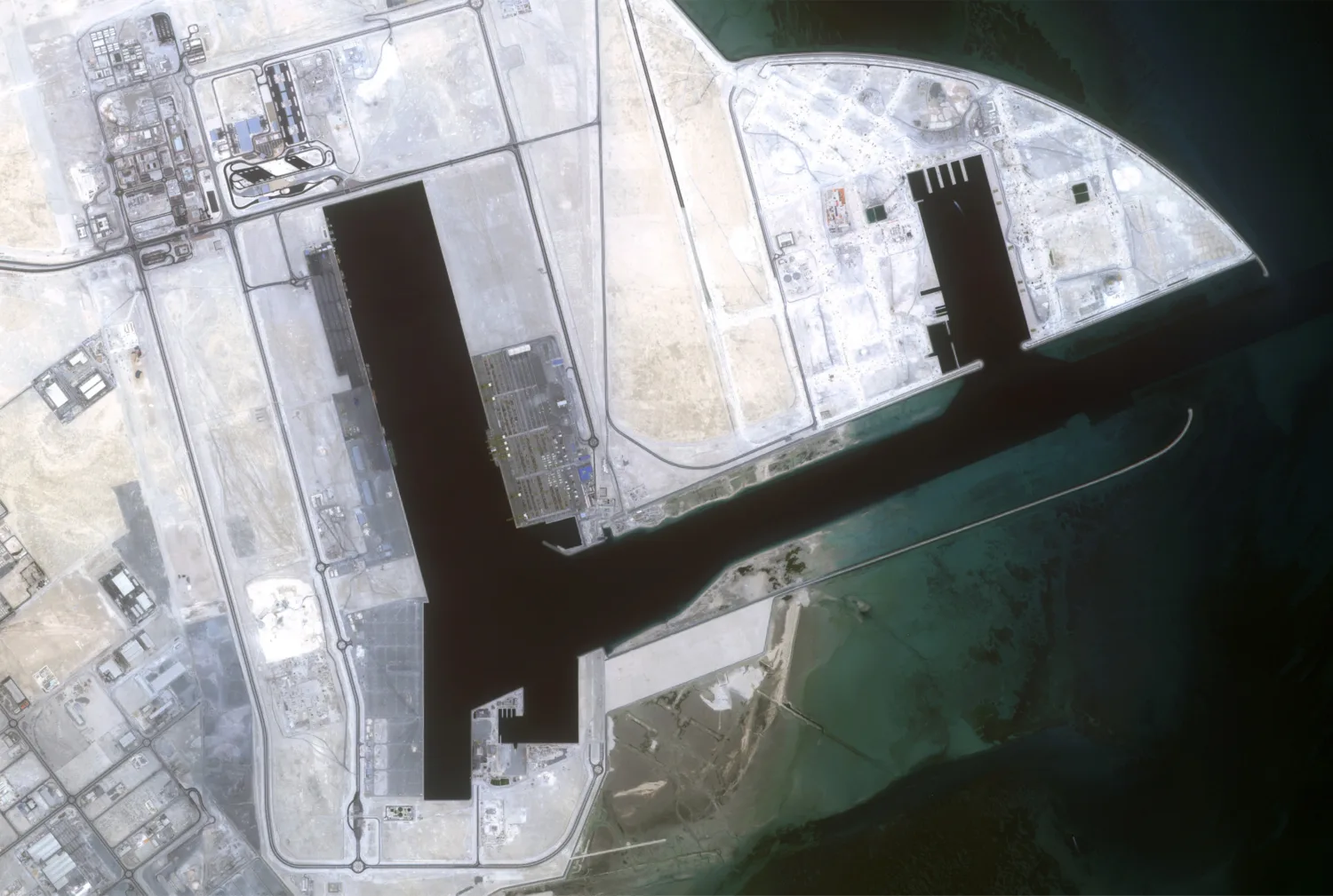 Aerial site view of white land and black-blue water