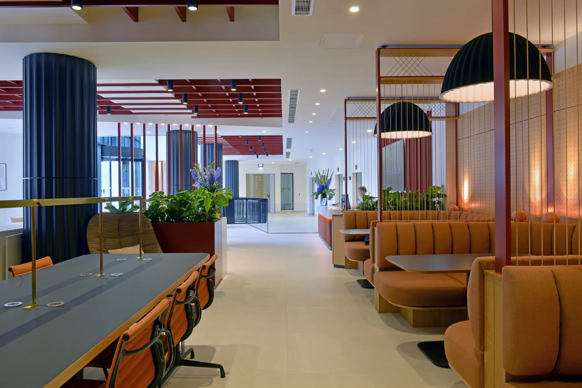 Interior view of open plan office space, range sofas and desks