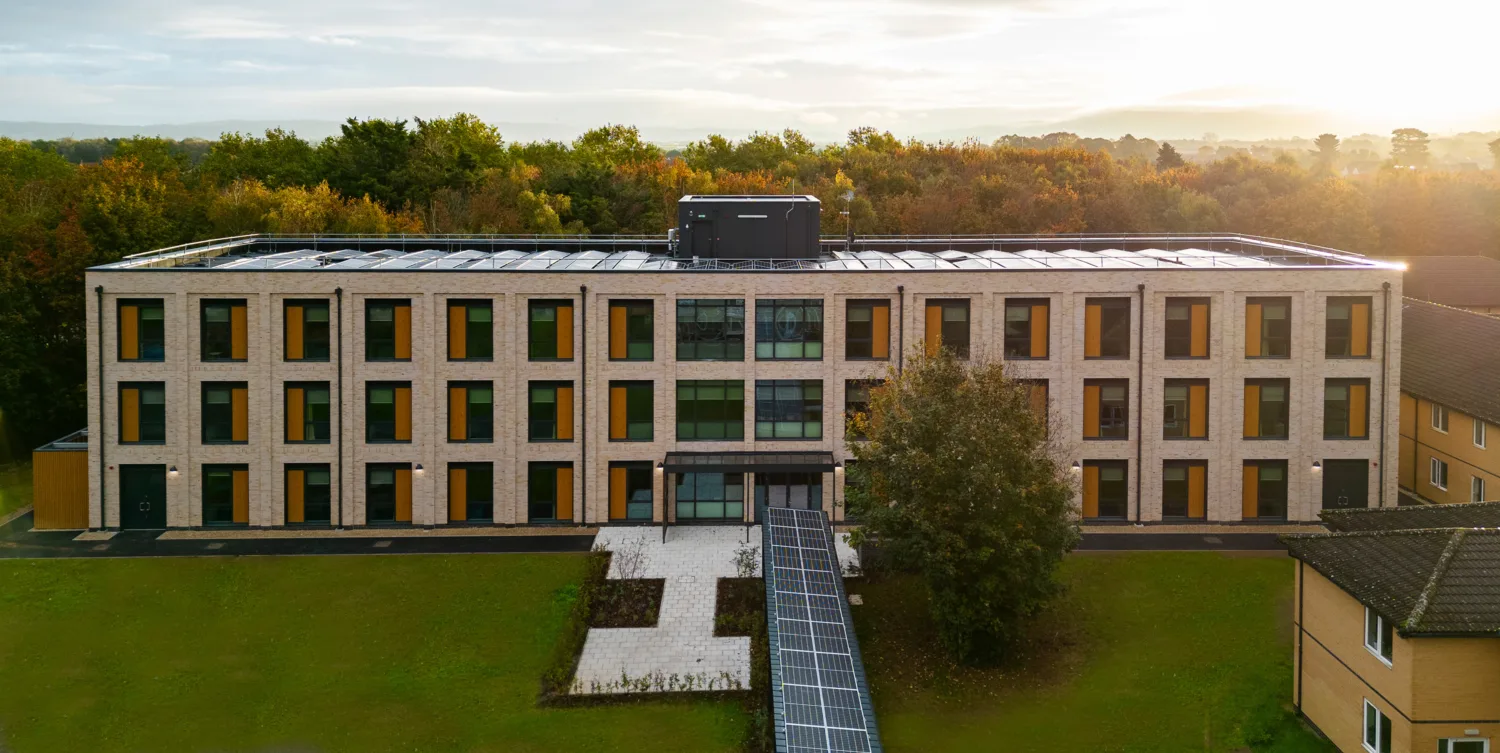 Aerial landscape shot of the exterior of Imjin Barracks in front of dense woodland at dusk