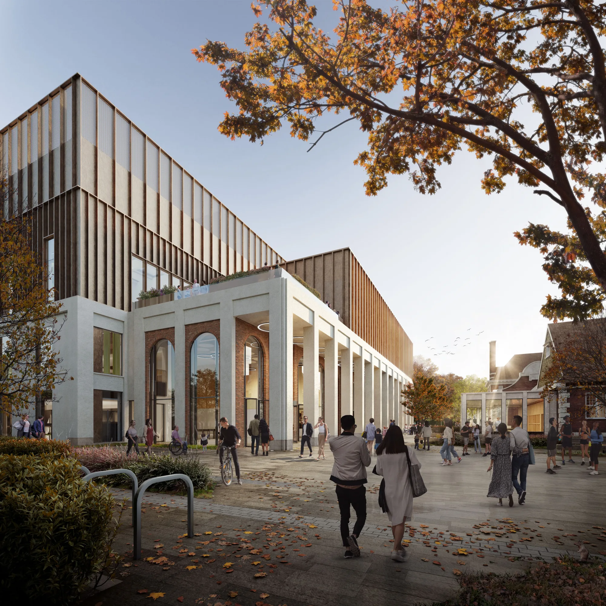 Computer generated image showing sideways view of building, particularly the pillars and arches leading to entrance of building. People are shown in the foreground, heading towards the building