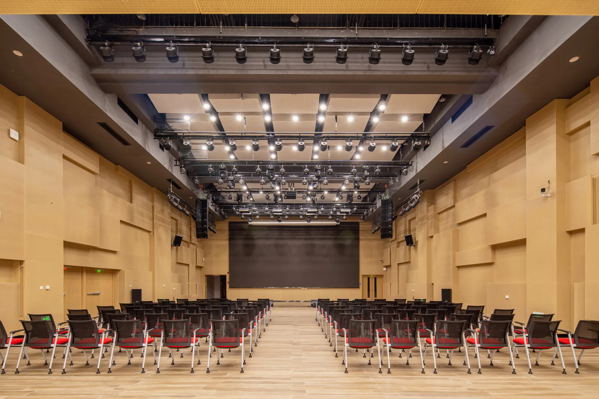 Main auditorium with theatre style rows of seating facing a dark screen