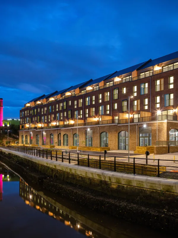 Night sky with the apartments illumination and reflected in the adjacent river