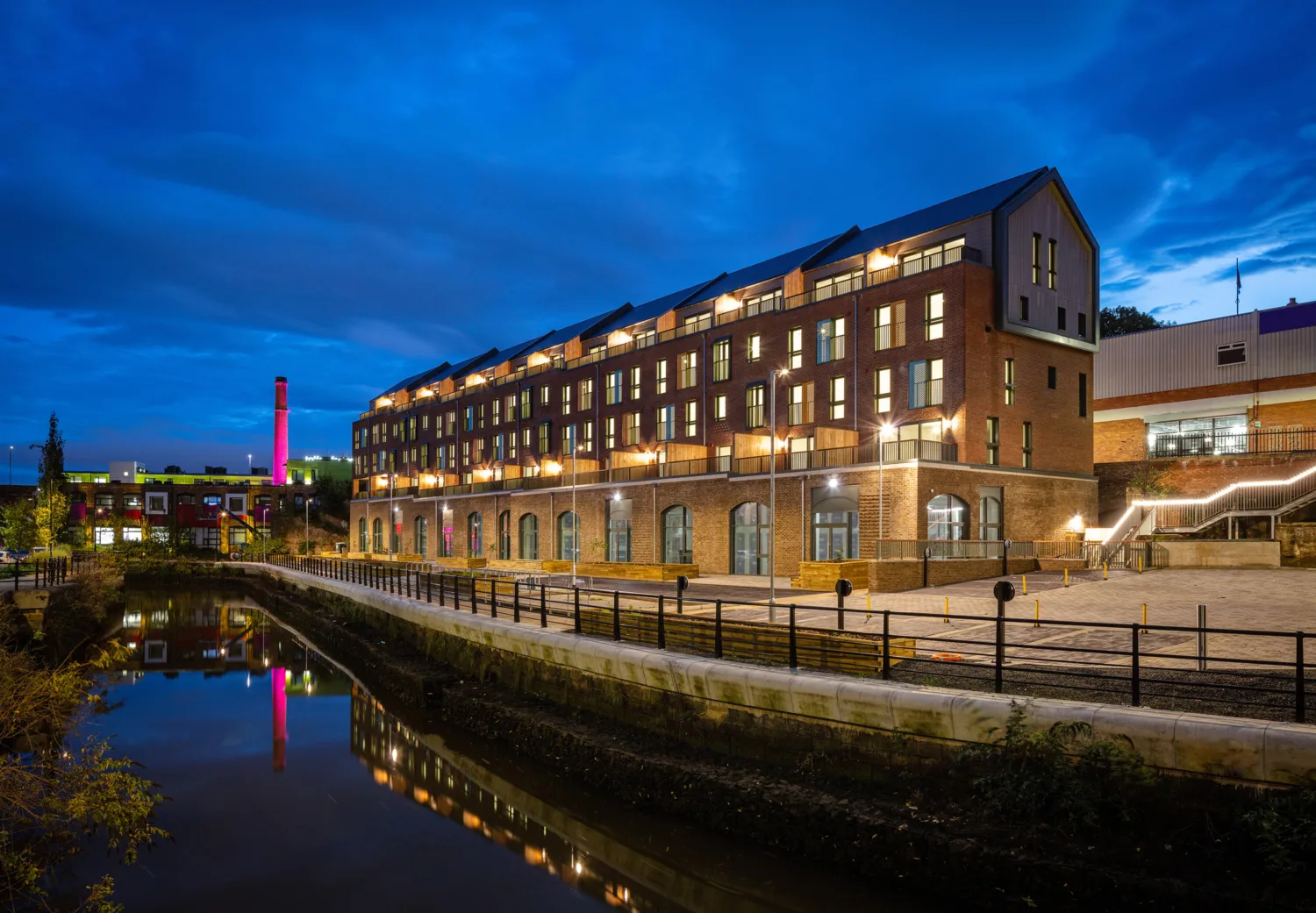 Night sky with the apartments illumination and reflected in the adjacent river
