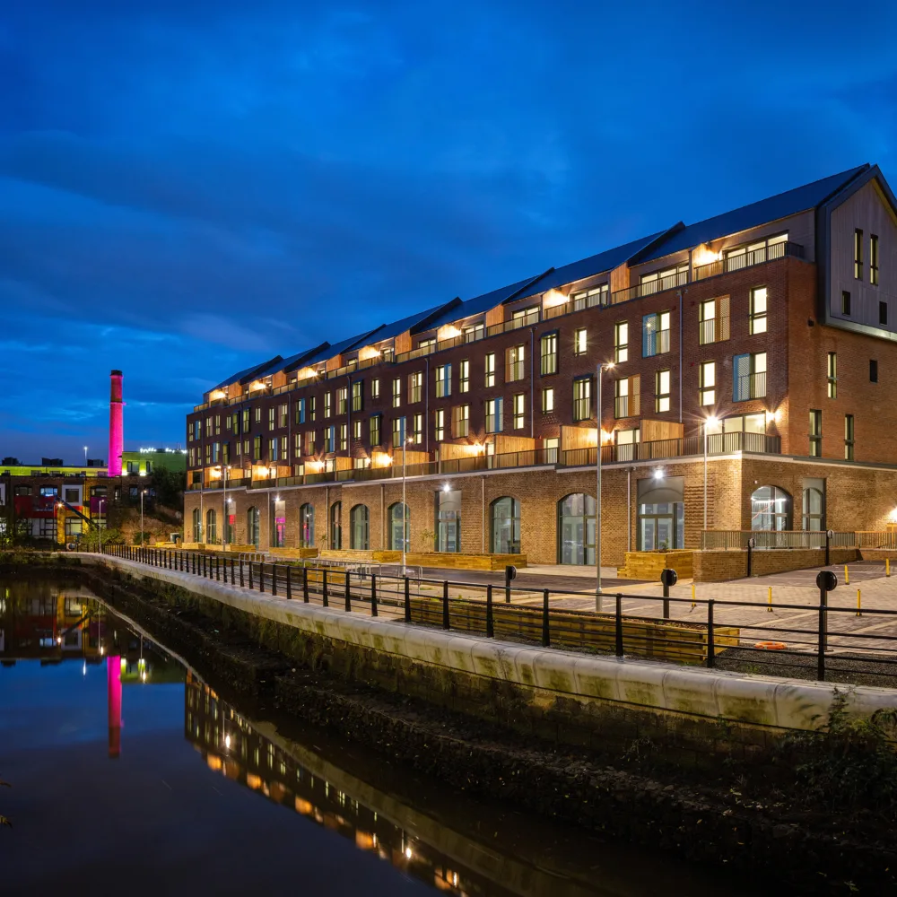 Night sky with the apartments illumination and reflected in the adjacent river