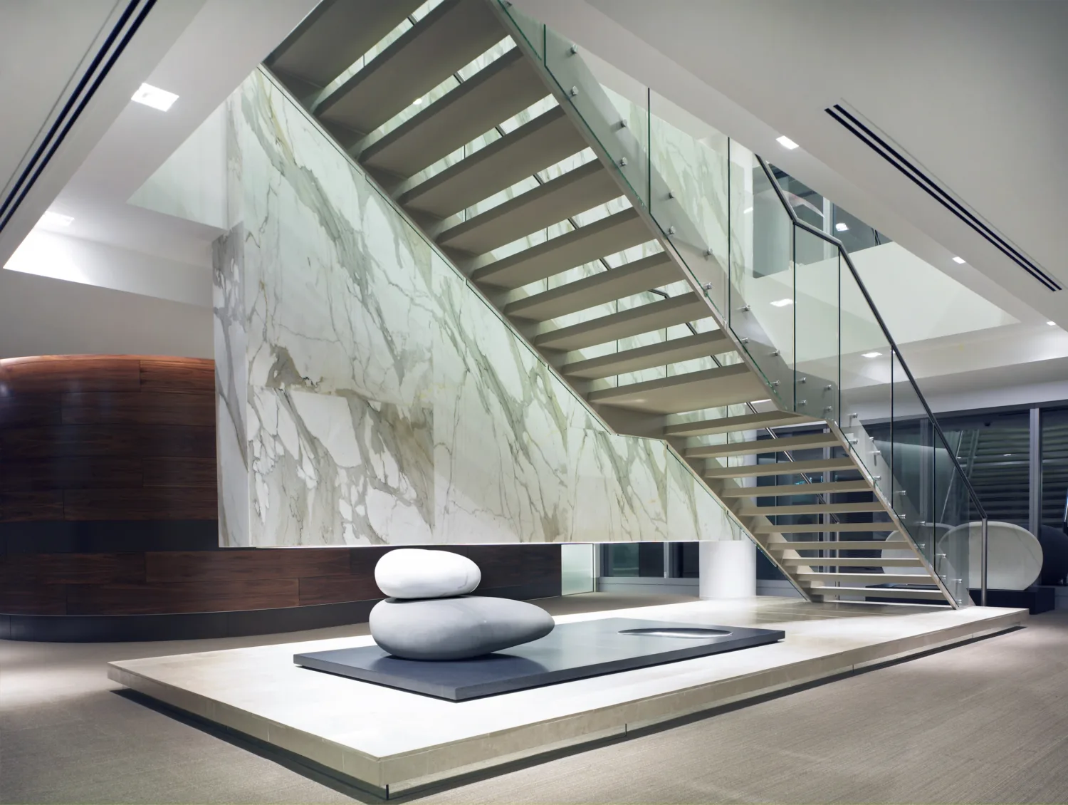 Rock sculpture below statement staircase.