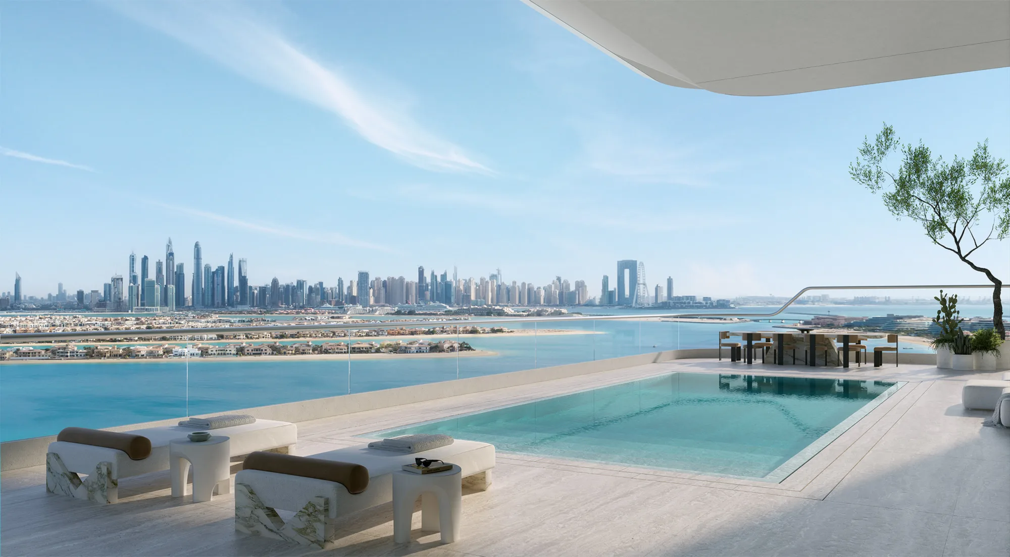 Infinity pool terrace overlooking a coastal skyline with high-rise towers. Glass balustrade, sun loungers, side tables and a shaded seating area sit above turquoise water and sandy islands.