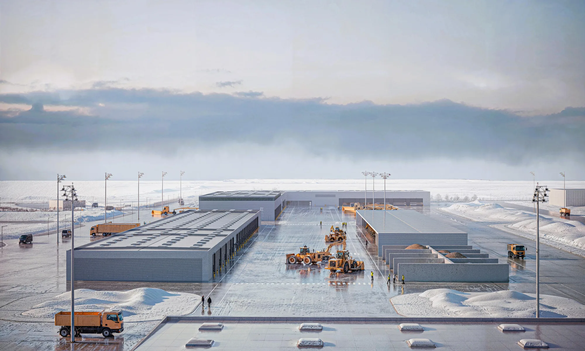 Elevated view of an industrial operations yard in a snowy landscape. Several rectangular buildings, yellow maintenance vehicles, trucks, and small human figures are distributed throughout the site. Tall lighting structures surround the area, with snow-covered terrain extending to the horizon. No visible text.