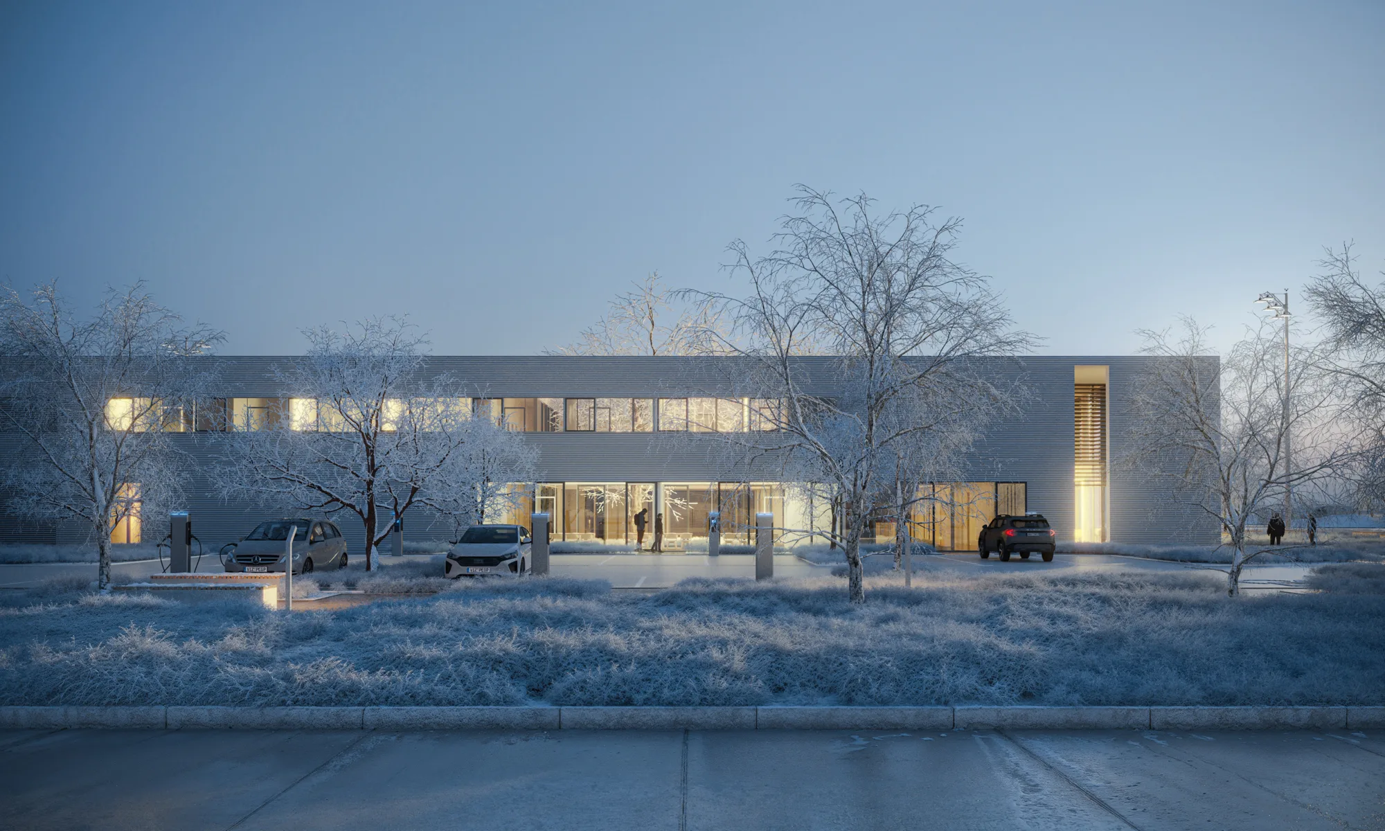 Modern two-story building in a winter landscape at dusk, surrounded by frost-covered trees and shrubs. Three parked cars and electric charging stations stand in front. Warm interior lighting shines through large windows, with several small human figures visible near the entrance. No visible text.