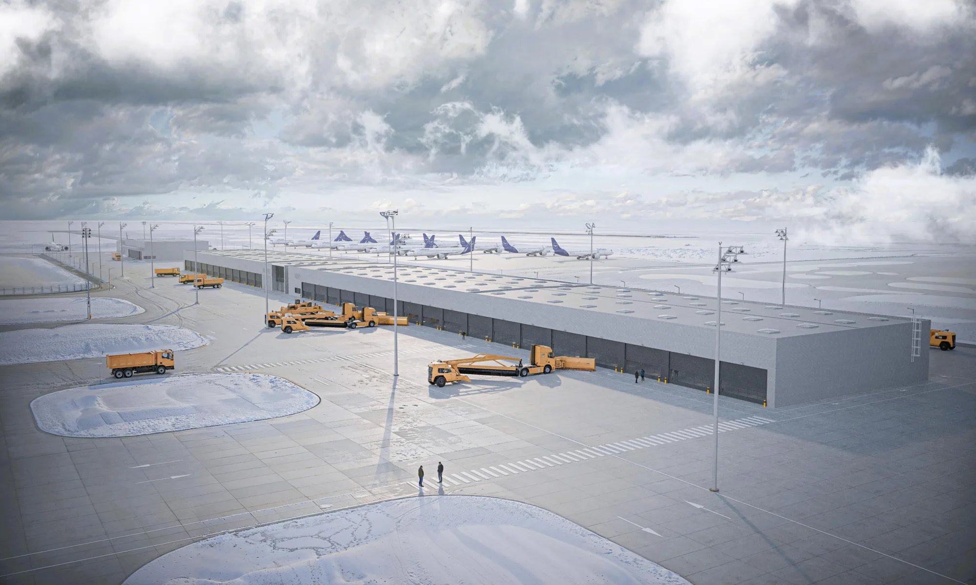 Aerial view of a large industrial facility in a snowy airport environment. Multiple yellow service vehicles are parked around a long rectangular building. Several aircraft are visible in the background near runways, with tall light poles, snow-covered ground, and two small human figures walking across the paved area. No visible text.